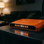 Routeur orange avec voyants LED allumés sur table
